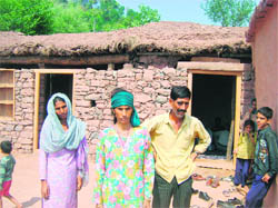 Sansar Singhs father, Prakash Singh, and mother Swarna (middle) stand forlorn outside their kutcha house in Jigni village, near Kalakote. 
